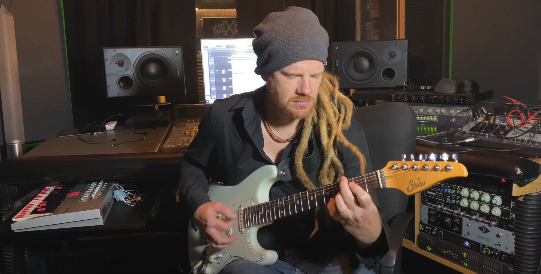Ben playing guitar in his studio