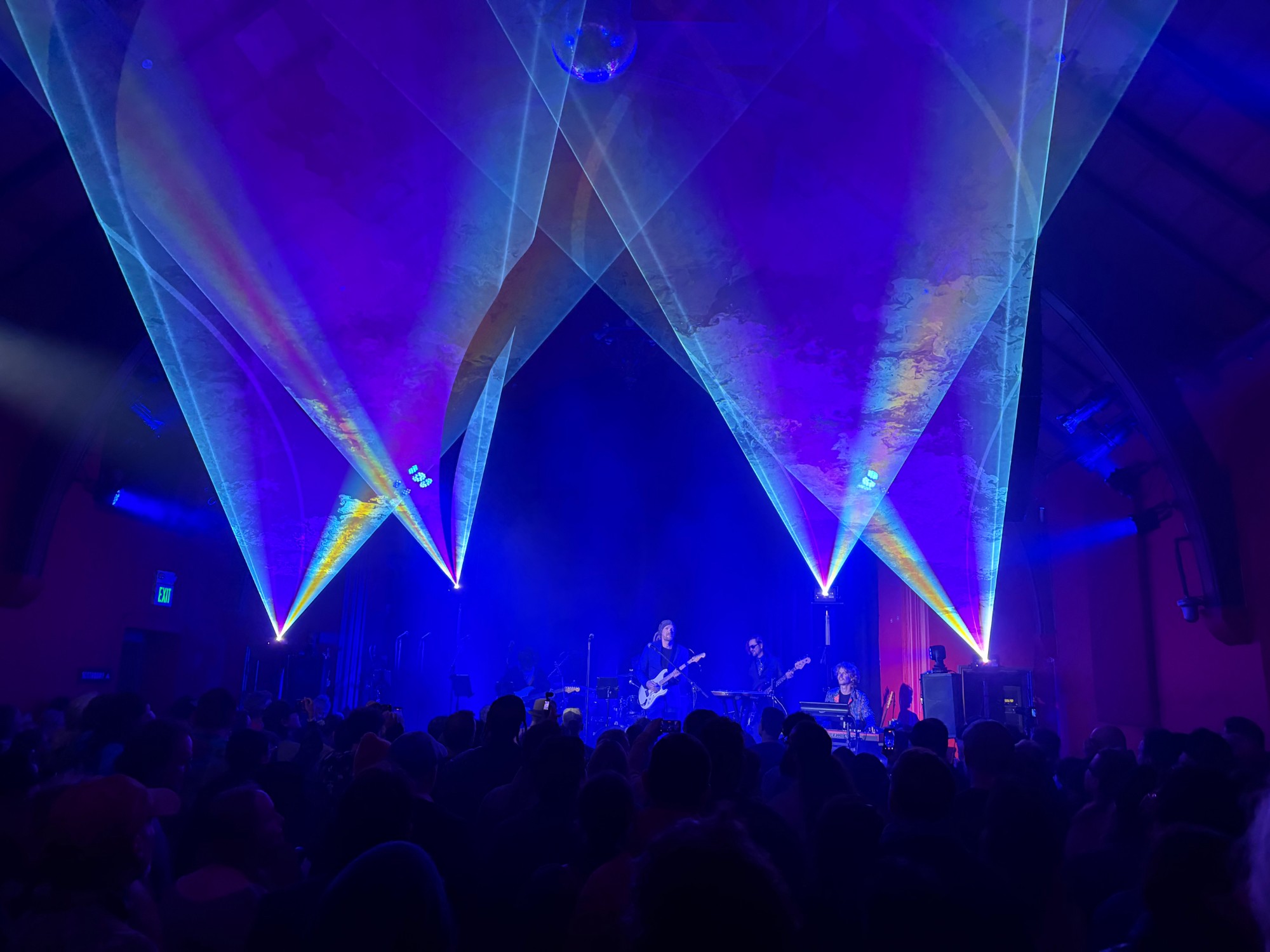 Ben and band on stage under blue laser lights